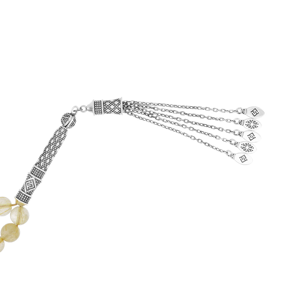 Natural rutile bead rosary with silver accents and handmade details for spirituality and prayer.