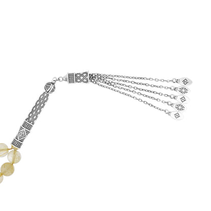 Natural rutile bead rosary with silver accents and handmade details for spirituality and prayer.